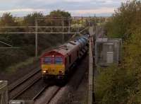 Train 384E, topped and tailed by DB 66's, is an RHTT from Bescot TMD to Euston. It was seven minutes early as it sprayed its way towards Hanslope Junction after passing through Northampton station and over the M1.<br><br>[Ken Strachan 13/10/2017]