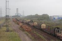 Baglan Bay Yard with logs waiting to be loaded onto the empty timber wagons for the return Colas train to Chirk. 18th October 2017.<br>
<br>
<br><br>[Alastair McLellan 18/10/2017]