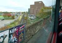 The 1018 Tweedbank - Edinburgh Waverley passing the site of St Margarets shed on 28 October 2017, seen from the top deck of a bus on London Road. At nationalisation the shed had an allocation of over 200 steam locomotives [see image 31096]. The site is now occupied by St Margarets House, a former government office building, now used as an arts centre providing studio, exhibition and event space.  <br><br>[Andy Furnevel 28/10/2017]