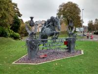 This fine scuplture, cleverly made out of straightened-out horse shoes, commemorates a local lad. It is also nicely positioned in what was the vee of Peebles Junction. The single-track Galashiels line went off to the left, and the non-passenger connection with the Caledonian station went right, the course of which is followed by a relief road created in the 1970s.<br>
<br>
It's not the only sculpture made of horseshoes<br>
<a href=http://www.geograph.org.uk/photo/3503282 target=external>Geograph -<br>
 Roundabout at Levenhall</a>.<br><br>[David Panton 19/10/2017]