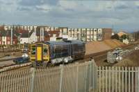 A short distance from Blackpool North station, at the start of the journey to York, a Northern Class 158 passes (on the left) the carriage sidings on 4th November 2017. The new washer plant (to the left of the leading carriage) and the sand and gravel piles for the rebuild of the station can be seen.<br><br>[John McIntyre 04/11/2017]