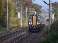 380 101 approaches with a service from Gourock.  To the left was the branch to ROF Bishopton; the junction has been removed but some track remains in the trees.  20 October.<br><br>[Bill Roberton 20/10/2017]