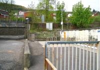 Scene at Bogston station in April 2007 looking towards the south entrance from Shankland Road. The bridge and embankment running across the picture carry the single line of the Wemyss Bay branch, while the overbridge from which the photograph is taken spans the station platforms, located on the Gourock branch [see image 15207]. There are no parking facilities here, but a bus stop is provided alongside the A8, which runs past the northern entrance to station at a lower level behind the camera. <br><br>[John Furnevel 29/04/2007]
