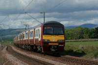 A pair of Class 320 units with 320307 leading, skirt the River Clyde approaching Brooks Road user worked LC between Ardmore East and Cardross on 28 May 2010. <br><br>[John McIntyre 28/05/2010]