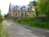 Looking east along Engine Road, Arniston, in 2017 showing the surviving refurbished colliery houses. Old maps identify these as 'Emily Bank', with 'Office Row' once running beyond. Opposite stood 'Engine Square' with the Old Engine Pit itself off picture to the left. The later Emily Pit  stood behind the camera on the south side of Engine Road. Several lines crossed the Road near here, including one that followed the curve of the garden wall in the foreground. [See image 50556]<br><br>[John Furnevel 06/10/2017]