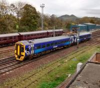 A 158 for Tweedbank slows right down (as required) to leave the ECML at Portobello on 26/10/2017. Behind it on the wheel lathe line are some Royal Scotsman coaches, finished with for the season. The seemingly rural background is deceptive: there's plenty of suburbia between Portobello Golf Course and Arthur's Seat.<br><br>[David Panton 26/10/2017]