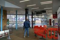 Passengers head for the exit from the Galashiels Interchange waiting area and  the A7 pedestrian crossing on 9 November 2017, just as the ScotRail 1029 Tweedbank - Edinburgh runs into the station on the other side of Ladhope Vale.<br><br>[John Furnevel 09/11/2017]