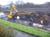 QTS getting near the end of embankment stabilisation work for Network Rail to the north of Ardrossan. Improved drainage and webbing have been installed along a stretch of the embankment following clearance of undergrowth and mature trees. It is suggested that Network Rail had concerns about potential movement in the embankment due to poor drainage.<br><br>[Douglas Blades 20/11/2017]