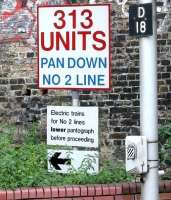 One of several similar signs intended for drivers of Silverlink class 313 dual voltage EMUs operating on the North London Line in the summer of 2005. This one is on the westbound platform at Dalston Kingsland station just before Boleyn Road bridge. Because of the mix of traction current supplies on the Richmond - North Woolwich route at that time drivers were required to switch between  third rail and overhead systems at four locations along the route (others being Hackney Wick, Camden Road and Acton Central). [See image 6230]<br><br>[John Furnevel 21/07/2005]