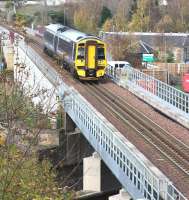 ScotRail 158726 is about to make its final crossing of the Gala Water on 9 November 2017 with the 0924 Edinburgh Waverley – Tweedbank. The train is just over half a mile north of Galashiels station, having passed the site of Kilnknowe Junction on the far side of the bridge. In the background stands the twin-arched road bridge carrying Kilnknowe Place across the railway, the leftmost arch of which was once used by trains on the Peebles branch [see image 28518].<br><br>[John Furnevel 09/11/2017]