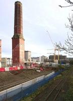 The preserved octagonal chimney at the former Shrubhill Tram Depot seen looking towards Leith Walk on 19 November 2017, with ongoing construction activity on the site gradually moving west towards the camera. The rusting rails of the Powderhall branch are visible bottom right.<br><br>[Andy Furnevel 19/11/2017]