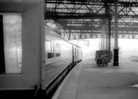 About to board a southbound InterCity 125 HST at Waverley on a particularly foggy day in September 1986. Between the power car and the loaded 'BRUTES' on the platform, the outline of a class 47 can just be made out approaching through the fog from the Calton Tunnel.<br><br>[John Furnevel 22/09/1986]