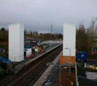 And that's before the stairs are added. The new lift towers at West Calder dominate the station (and the vicinity) in this view on 24 November. The construction compound for the structure is at this, the eastern end of the station while the plant visible in the background is in the OHLE compound. The comparatively graceful footbridge and original station building are in between.<br><br>[David Panton 24/11/2017]