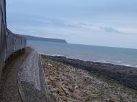 David Hindle's new book, <I>Enjoying the Cumbrian Coast Railway</I>, will be published in December 2017. [See image 61899]. Currently the best way to enjoy the route is on one of the Class 37 hauled passenger trains, but only until January 2019. The DBSO is leading this set along the exposed single track section at Parton, with the locomotive providing the sound effects at the rear. St. Bees Head can be seen in the distance as the train runs south heading for Barrow-in-Furness on 13th November 2017. <br><br>[Mark Bartlett 13/11/2017]