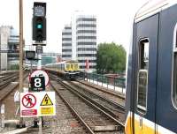 Looking south across the River Thames from the end of platform 4 at the old Blackfriars station in the summer of 2005. Thameslink unit 319381 has just received a green light and is about to restart a Luton - Sutton service, just as sister unit 319367 crosses the river northbound with the reverse working. In the left background Southeastern unit 465185 has stopped on the approach to Blackfriars Junction with a service to Rochester which has recently departed from bay platform 3.<br><br>[John Furnevel 23/07/2005]