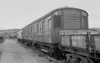 Former Perth engineer's DE321056 waits for the final trip to R M Supplies scrapyard at Inverkeithing Bay in 1988, along with a Mk1 coach and Turbot wagon. A class 26 is in the background with ballast hoppers.<br>
<br><br>[Bill Roberton //1988]