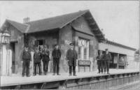 Undated photograph of station staff at Grantshouse. Under magnification, the chap on the right has an LNER cap but the 'Come Back to Erin' poster inside the shelter is Midland Railway with the one to the left of it an LNER system map so the photograph is possibly early 1920s just into the LNER period.<br><br>[Douglas Blades Collection //]