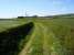 From Glengarnock Iron Works a line headed west to serve ironstone pits and<br>
also south to serve coal mines in the Dalry area. After passing along what<br>
is now Balgray Road and on into Loadingbank the line turned south. At this<br>
point the track bed is now a well kept farm track but the sweeping curve<br>
gives a good clue to its original use.<br><br>[Douglas Blades 05/05/2017]