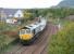 Freightliner 66952 brings up the rear of a freight from Millerhill south sidings about to run through Niddrie West Junction on the morning of Sunday 8 October 2017. The concrete sleepers are destined for Keith.<br><br>[John Furnevel 08/10/2017]