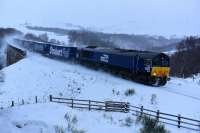 In the midst of a snow shower, the wind from the container train causes the powdered snow to rise and produce a smoke like effect.66433 is heading for Mossend and is a hour late at Slochd.<br><br>[John Gray 08/12/2017]