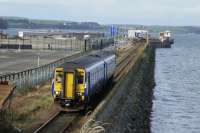 The 13.04 to Kilmarnock comes off the causeway from Stranraer Harbour station and is about to pass under the A77 road bridge. 29th October 2017.<br>
<br>
<br><br>[Colin Miller 29/10/2017]