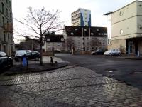 The NBR line to North Leith and its goods station continued across<br>
Commercial Street (running left-right in front of the houses) to enter the<br>
Docks at this point. Tracks remain in place in the foreground, though those<br>
crossing the road and into the Old Dock have long gone. The NBR station<br>
building is still there, hidden by the former Highland Queen whisky bond on<br>
the extreme left. The houses occupy the site of the goods station.<br>
<br>
<br><br>[David Panton 02/12/2017]