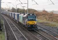 88003 <I>Genesis</I> approaches Hest Bank level crossing with its pantograph well extended on 4th December 2017. The <I>Tesco Express</I> has seen a variety of diesel and electric traction over recent years [See image 28531]. It is still the only regular booked working for the Class 88 electro-diesels at this time. <br><br>[Mark Bartlett 04/12/2017]
