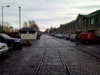 These lines served the East and West Old Docks (left) and the warehouses on<br>
the right. These buildings front on to the unashamedly-named Commercial<br>
Street. The palatial building on the extreme left is the main office of the<br>
Scottish Government at Victoria Quay. I don't know whether the tracks have<br>
been retained for heritage reasons, or because it would entail too much<br>
work to remove them and seemlessly replace them with setts (cobbles to you).<br>
<br>
<br><br>[David Panton 02/12/2017]