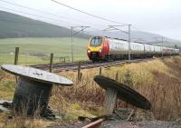 A lengthy Virgin Voyager combination runs south at Wandel Mill on a wet and windy Christmas Eve 2017. The train is the 1051 Edinburgh - Lancaster, which replaced the normal Euston Pendolino service due to WCML engineering works in Lancashire.<br><br>[John Furnevel 24/12/2017]