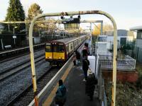 A 6-car Gourock to Glasgow service pulls into Hillie East on 16 December 2017. It is composed of doomed class 314s, to be scrapped next year. It's now clear why they haven't bothered to paint most of them out of the long-redundant SPT livery. The rusting footbridge I am standing on is the only reasonable access to this platform from the ticket office and most of the custom: it is surely ripe for replacement with an accessible one - if they can find room.<br>
<br>
<br><br>[David Panton 17/12/2017]