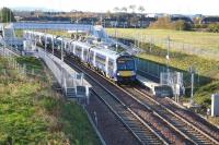 Scene at a quiet Shawfair station on Sunday 12 November 2017, with the 0845 from Tweedbank pausing on its journey to Edinburgh. In the background is the former mining village of Newton, most recently associated with Monktonhall Colliery which stood off to the left [see image 50741]. This whole area lies within the boundary of Shawfair new town, with various housing and commercial developments underway in the surrounding area (note the new buildings in the right background beyond the rooftops of the village).  Growth of the new town will doubtless be reflected in a steady increase in rail passengers.<br><br>[John Furnevel 12/11/2017]