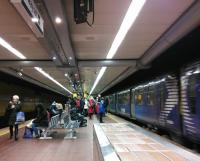 A Dalmuir service pulls out of Argyle Street on Saturday 16th December 2017 while its many disgorged passengers queue for the exit and Argyle Street's shops. Those in the foreground, their shopping done, can afford to relax and await their train back to Lanarkshire.<br>
<br>
<br><br>[David Panton 16/12/2017]