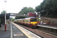 SPT liveried 320317 pulls up below the booking office at Garrowhill on 1 September 2006 with an Airdrie - Helensburgh Central service.<br><br>[John Furnevel 01/09/2006]