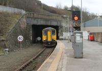 The tunnel entrance at Whitehaven is misleading, as a girder bridge of double track width conceals the single track bore that runs to Corkickle. 153352 emerges to call at Whitehaven on its way to Carlisle with a coastal stopping service. The signal isn't controlled from Bletchley of course but Bransty signalbox, which was the original supplementary name of this station. <br><br>[Mark Bartlett 13/11/2017]