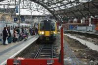 A pair of London & Northwestern Class 350 EMUs arrive at Liverpool Lime Street on 30 December 2017. On the right behind a barrier is track-less former platform 6 which is currently undergoing a rebuild.<br><br>[John McIntyre 30/12/2017]