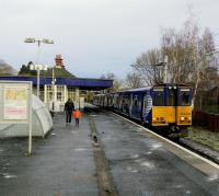 First stop on the Neilston branch is Muirend, one of several comfortable<br>
suburbs served by the Cathcart lines. On a cold 16th December 2017 a Neilston bound Class 314 pulls out as its last two (well, one and a half) passengers make<br>
their way to the Muirend Road exit.<br>
<br>
<br><br>[David Panton 16/12/2017]