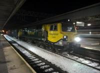 It's behind you! There are ugly loco's all over in this pantomime season. Freightliner 70003 lurks in the gloom with train 487S from Trafford Park FLT to Southampton MCT, while an up Pendolino speeds past platform 4.<br><br>[Ken Strachan 11/12/2017]