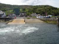 A view of Lochranza slipway on Arran, from the Calmac Ferry <I>MV Loch Riddon</I> as it starts its 30 minute journey across the Kilbrannan Sound to Claonaig on Kintyre. 17th June 2013.<br><br>[David Pesterfield 17/06/2013]