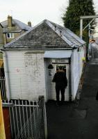 A few Scottish stations have ticket windows where the 'ticket office' is<br>
only on the staff side of the glass. Hillington East's is surely the most<br>
exposed, with protection from only completely vertical rain and for only<br>
one customer. 16th December 2017. <br>
<br><br>[David Panton 16/12/2017]