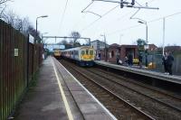 Northern Class 319s arrive and depart from Whiston as darkness falls on 30 December 2017. On the left a stopping service to Manchester Victoria heads east as a stopping service to Liverpool arrives on the adjacent platform.<br><br>[John McIntyre 30/12/2017]