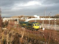 Freightliner 66956 about to run back towards the south sidings at Millerhill on 1 January 2018. The junctions for the new ScotRail EMU Depot can be seen in the left background, with the depot itself located off to the right beyond the wire fence. <br><br>[John Furnevel 01/01/2018]