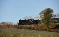 The distinctive profile of BR Standard 4MT 2-6-0 76017, on the return trip to Ropley, seen slightly to the west of Medstead on 28th December 2017.<br>
<br>
<br><br>[Peter Todd 28/12/2017]