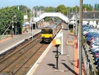 An SPT liveried class 318 EMU arriving at a very quiet Kilwinning platform 2 on 3rd May 2007 forming a Glasgow Central - Largs service.<br><br>[John Furnevel 03/05/2007]