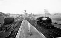 Kintore, looking north on 12th August 1958. Class J38 65911 passing southbound, ex-works from Inverurie. In the distance the branch to Alford (left) and the main line to Keith divide.<br><br>[David Murray-Smith 12/08/1958]