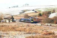 A chilly day at Heriot on 27 December 2017 as ScotRail 170454 runs south through the site of the old station with an early afternoon service on the Borders Railway. The train in question is the 1254 Edinburgh Waverley - Tweedbank. Note the bus shelter alongside the A7  just to the right of the train.   <br><br>[John Furnevel 27/12/2017]