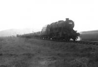 A trainload of bombs destined for Loch Ryan heading west on the Port Road near Loch Skerrow in the summer of 1956. Locomotive in charge is Stanier 8F 2-8-0 48157. [Ref query 15 January 2018]  <br><br>[G H Robin collection by courtesy of the Mitchell Library, Glasgow 14/07/1956]
