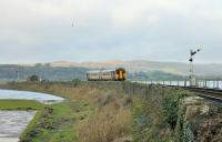 High tide in the Kent Estuary as refurbished Northern Sprinter 156481 comes off the viaduct and slows for the Arnside stop on 1st January 2018. <br><br>[Mark Bartlett 01/01/2018]