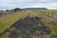 View south alongside Loch Leven. I'm not sure where exactly Loch Leven Curler's Platform was located but here, where the loch is not far to the left, seems likely. The tragic remains of a telegraph pole sits on the ballast.<br><br>[Ewan Crawford 12/01/2018]