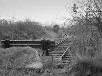 Looking south from Wallace Street past the buffer stop at Springfield Yard, Falkirk.  SRPS stock fills the yard pending removal to Bo'ness later in the year.  Rails formerly continued behind the camera to several industrial customers.  <br>
<br><br>[Bill Roberton //1987]