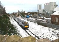 ScotRail 170418 runs south towards Gorebridge shortly after leaving Newtongrange on 21 January 2018. The train is passing the industrial site occupying the yard that once served Lady Victoria Colliery, with the old NCB locomotive shed still standing on the extreme right [see image 6114]. <br><br>[John Furnevel 21/12/2018]